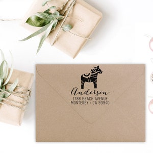 May include: A brown envelope with a black and white illustration of a Dala horse and the text "Anderson 1786 Beach Avenue Monterey - CA 93940".