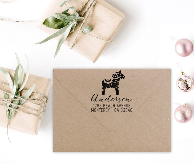 May include: A brown envelope with a black and white illustration of a Dala horse and the text "Anderson 1786 Beach Avenue Monterey - CA 93940".