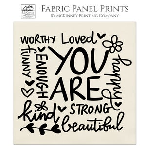 May include: A beige fabric panel print with black text that reads "Worthy Loved You Are Kind Strong Beautiful" with hearts and flowers surrounding the words. The print is made from 100% Kona cotton fabric.