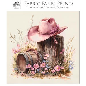 May include: Fabric panel print featuring a watercolor illustration of a pink cowboy hat adorned with flowers, resting on a wooden post. A small barrel and wildflowers complete the rustic scene. The text "FABRIC PANEL PRINTS" is visible.
