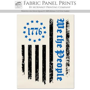 May include: A beige cotton fabric panel print featuring a distressed American flag design with the text "1776" and "We the People" in blue.