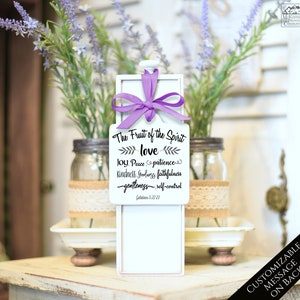 May include: A white wooden box with a pull-out drawer, adorned with a purple ribbon. The front features the text "The Fruit of the Spirit" and related words. The box is displayed with lavender and mason jars.
