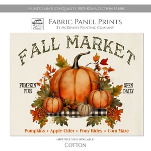 May include: Fall Market fabric panel print featuring a watercolor illustration of pumpkins, leaves, and a checkered tablecloth. The text "Fall Market" is in a vintage style font. The text "Pumpkin Pies" and "Open Daily" are also included. The text "Pumpkins, Apple Cider, Pony Rides, Corn Maze" is at the bottom of the print. The text "(Multiple Sizes Available) Cotton" is at the bottom of the print.