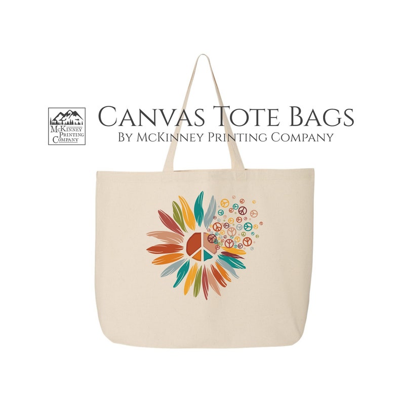 May include: A beige canvas tote bag with a colorful peace sign sunflower design. The bag has two handles and the text "CANVAS TOTE BAGS BY MCKINNEY PRINTING COMPANY" is printed on the top.