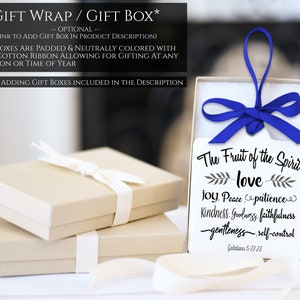 May include: A stack of beige gift boxes with ivory ribbon and a gift tag inside a white box tied with a blue ribbon. The gift tag reads "The Fruit of the Spirit" followed by a list of virtues.