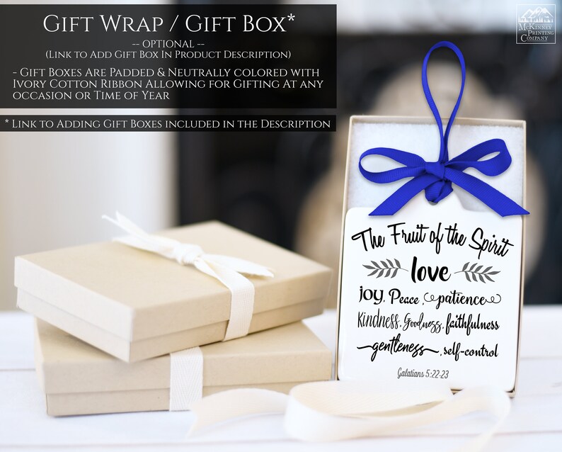 May include: A stack of beige gift boxes with ivory ribbon and a gift tag inside a white box tied with a blue ribbon. The gift tag reads "The Fruit of the Spirit" followed by a list of virtues.