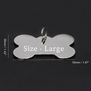 May include: Silver bone-shaped dog tag with a ring for attaching to a collar. The tag is 1.97 inches long and 1.42 inches wide. The tag is engraved with the text "Size - Large".