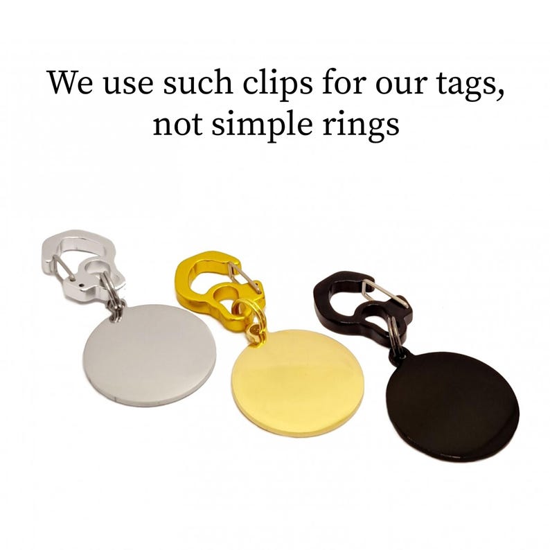 May include: Three round metal dog tags with different finishes: silver, gold, and black. Each tag has a metal clip attached.