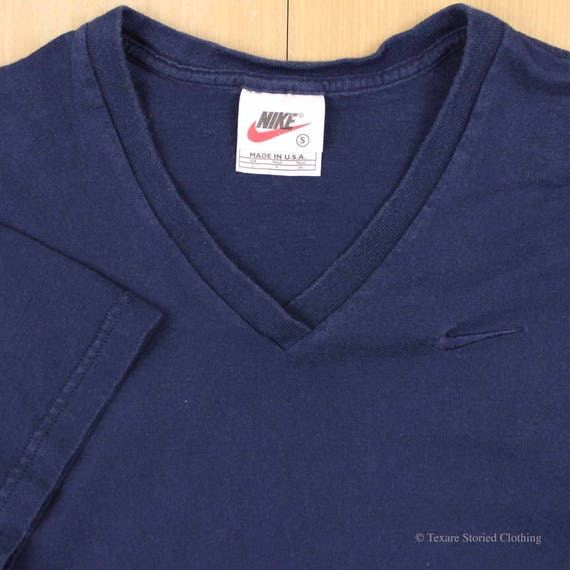 navy blue and orange nike shirt