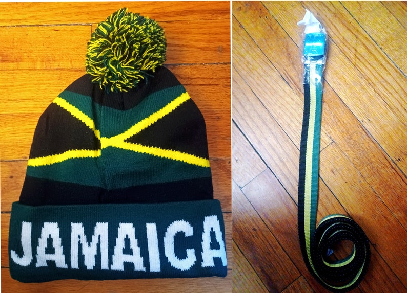May include: A green, black, and yellow knit beanie with a pom pom on top. The beanie has the word "JAMAICA" written in white on the front.