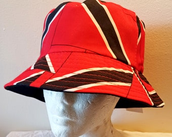 May include: A red, black, and white bucket hat with a geometric pattern. The hat is made of a soft, comfortable fabric and has a wide brim.
