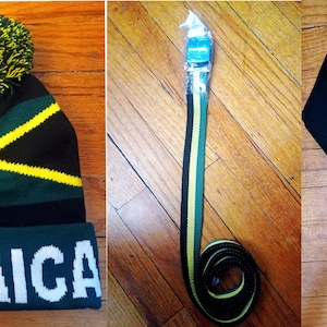 May include: A set of three Jamaican themed accessories: a black, green, and yellow knit beanie with a pom-pom, a black, green, and yellow striped belt, and a black, green, and yellow striped scarf with black tassels.