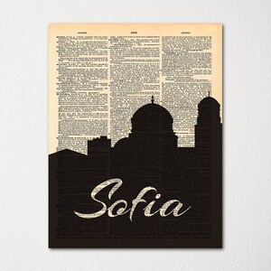 May include: A black and white illustration of the city skyline of Sofia, Bulgaria, with the word "Sofia" written in a stylized font on a vintage dictionary page background.