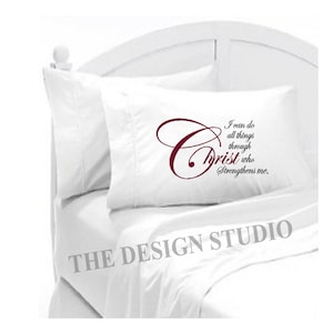 May include: White pillow with a burgundy embroidered quote: "I can do all things through Christ who strengthens me."