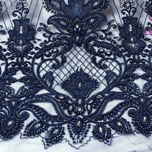 May include: Navy blue beaded lace fabric with a floral design. The lace is embellished with small, round beads and clear rhinestones.