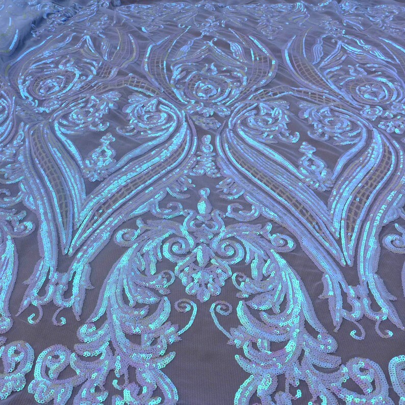 May include: White iridescent sequins on a mesh fabric with a damask pattern.