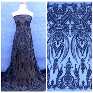 May include: Black sequined fabric with a damask pattern. The fabric is sheer and has a delicate, intricate design.