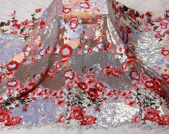 May include: Silver sequin fabric with embroidered red, pink, and blue flowers. The fabric has a sheer, mesh-like texture.