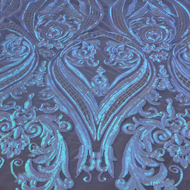 May include: White iridescent sequins on a mesh fabric with a damask pattern.