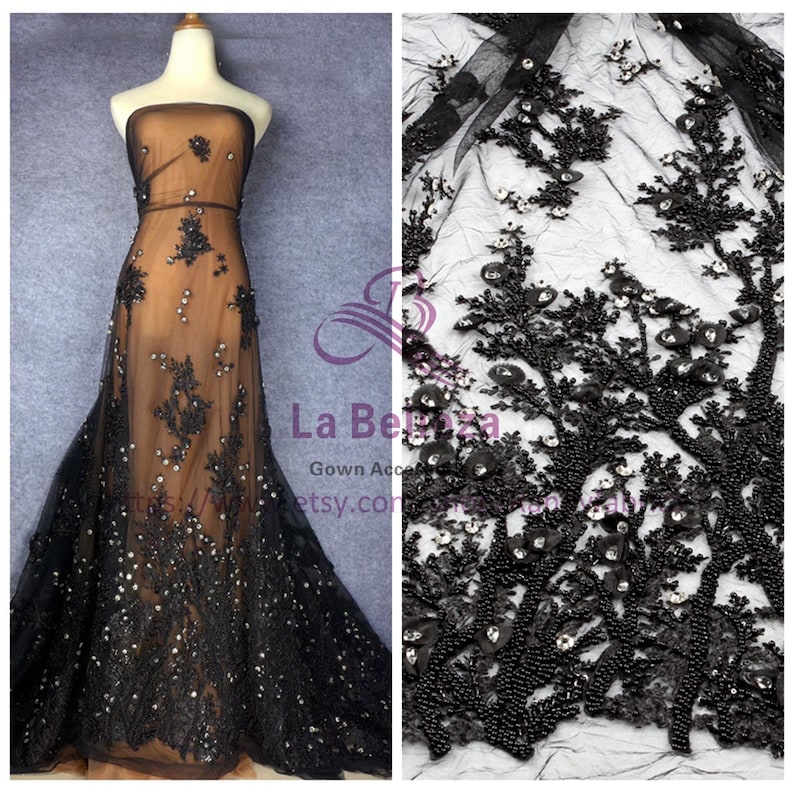 May include: Black beaded lace fabric with a floral design. The lace is on a sheer mesh background. The fabric is shown on a dress form and as a close-up.