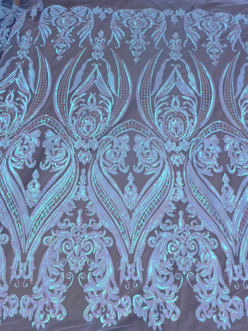 May include: A light blue iridescent fabric with a damask pattern. The fabric is made of sequins and mesh.