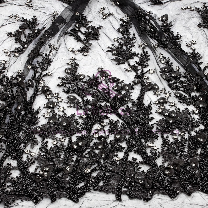May include: Black beaded lace fabric with a floral design. The fabric is made of a sheer mesh with black beads and sequins.