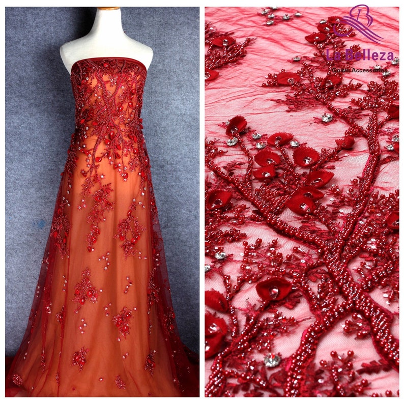 May include: Red beaded lace fabric with a floral design. The fabric is sheer and has a delicate texture. The beads are small and evenly spaced.