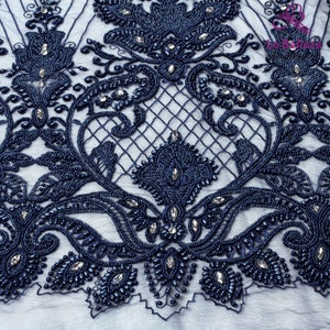 May include: Navy blue beaded lace fabric with a floral design. The lace is embellished with small, round beads and rhinestones.