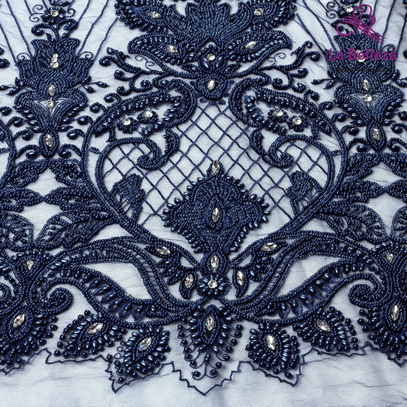 May include: Navy blue beaded lace fabric with a floral design. The lace is embellished with small, round beads and rhinestones.