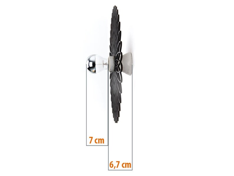 May include: Black and white wall sconce with a geometric design. The sconce is 7 inches tall and 6.7 inches wide.