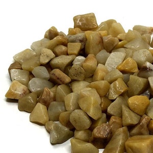May include: A pile of small, smooth, light brown and white stones. The stones are various shapes and sizes.