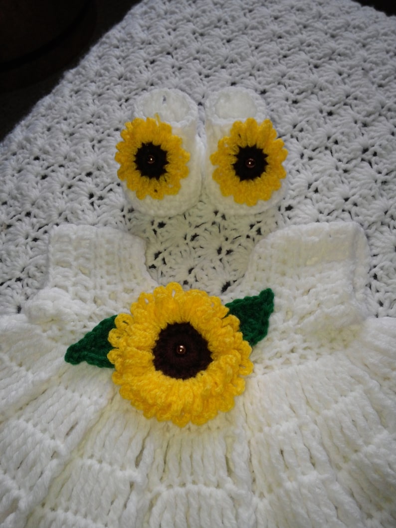white crochet baby dress with sunflowers.
