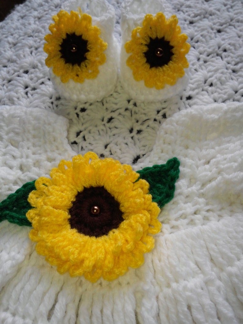 white crochet baby dress with sunflowers.