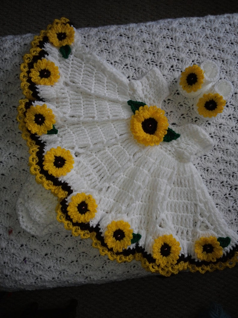 white crochet baby dress with sunflowers.