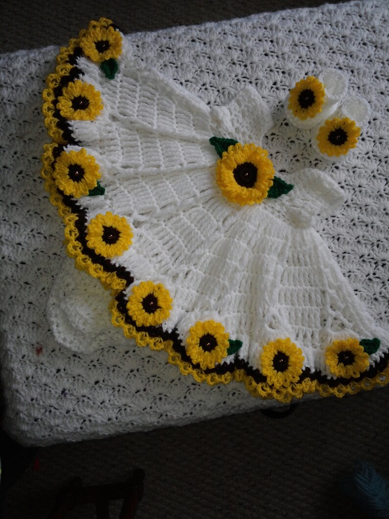 white crochet baby dress with sunflowers.