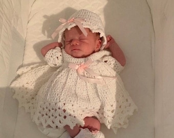 Pretty white crochet baby dress outfit, comes with hat and shoes, the ribbon and roses color may be different.