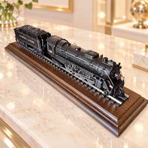 May include: A black Lionel Lines model steam locomotive and coal tender set resting on a dark wooden display base with metal train tracks. The engine features the number 726 on the side, intricate mechanical detailing, and small red and blue accents.