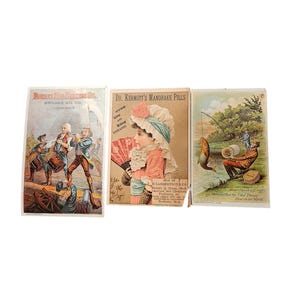 May include: Three antique advertising cards. The first card shows a military scene and text for Brooks Oil Co. The second card advertises Dr. Kermott's Mandrake Pills. The third card shows a man fishing with text that reads "Merrick's Best Six Cent Thread."