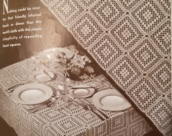 May include: A close-up of a crocheted tablecloth with a square pattern. The tablecloth is white and has a delicate, lacy design. The text "Nothing could be nicer for that friendly informal lunch or dinner than this motif cloth with the classic simplicity of repeating lacet squares." is visible in the image.