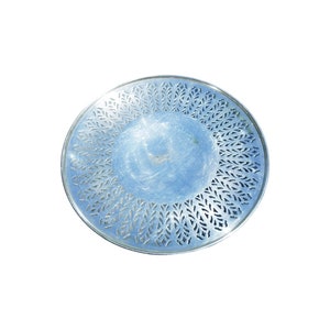 May include: A silver serving tray with a decorative, cut-out design of leaves around the edge.