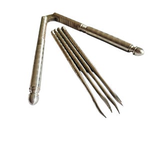 May include: A silver-toned nutcracker with textured handles and a curved design. Four slender picks with curved tips are also included. The tools are arranged on a white background.