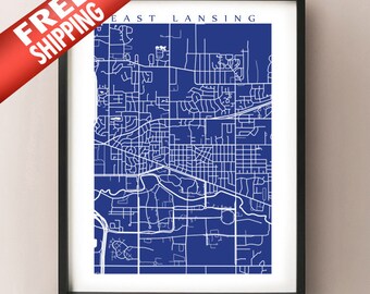 Könnte beinhalten: Gerahmter Druck einer Karte von East Lansing, Michigan, mit weißen Linien auf dunkelblauem Hintergrund. Die detaillierte Karte zeigt Straßen und Gebäude. Der Druck ist in einem schwarzen Rahmen. Oben steht "East Lansing".