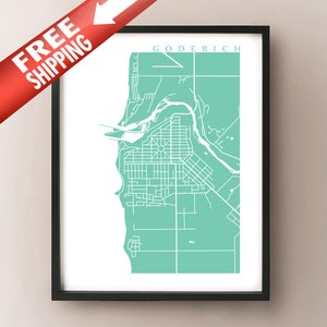 May include: A framed print featuring a minimalist map of Goderich, Ontario, in white lines against a teal background. The town's name is printed at the top. The print is in a black frame.