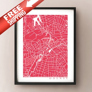 May include: Framed print of a map of Odense, Denmark, in a vibrant red and white color scheme. The map details the city's streets and landmarks. The print is encased in a black frame. The words "ODENSE" are printed at the bottom.