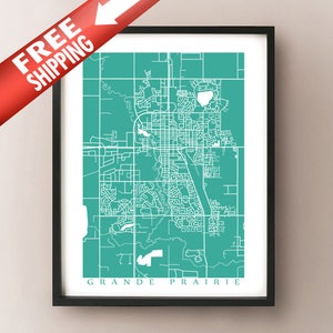 May include: A framed teal and white map print of Grande Prairie, Alberta, Canada. The map features a detailed street layout and is set against a teal background. The print is in a black frame.