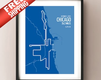 May include: Framed print showing the Chicago Marathon course in blue and white. The text states "Chicago 26.2 Miles 4:29:50" and "October 11, 2015". The print is in a black frame.