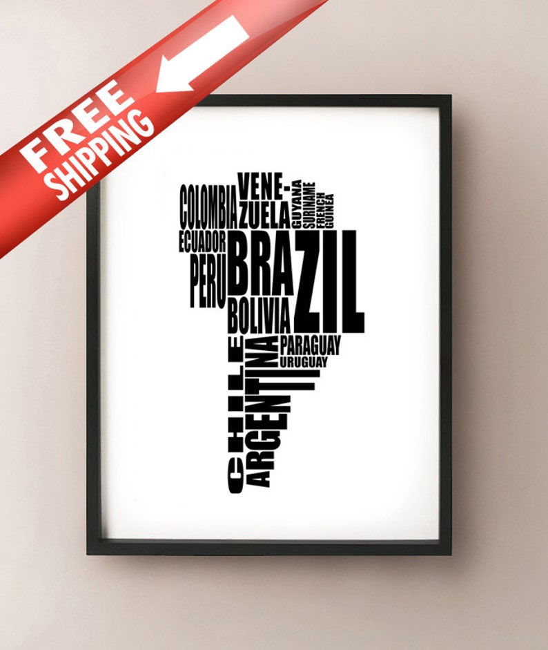 May include: A framed print featuring a black and white map of South America, composed of country names. The word "BRAZIL" is prominently displayed. A red banner with the text "FREE SHIPPING" and a white arrow is in the upper left corner.