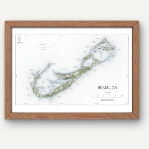 May include: A framed map print of Bermuda. The map shows the island's topography with contour lines and place names. The print is in a wooden frame and includes the text "Bermuda" and a scale of 1:75,000.