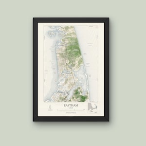 May include: A black framed map of Eastham, Massachusetts. The map shows the coastline, roads, and other geographical features of the town. The map is printed on white paper and has a light gray background.