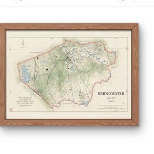 May include: A framed map of Bridgewater, Massachusetts, with a detailed topographical layout. The map features green, beige, and blue hues, with the town's name prominently displayed. The wooden frame adds a classic touch to the artwork.
